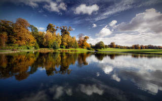 Lake trees clouds golf course 5 - a green field and trees free wallpaper