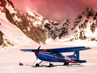 Blue airplane snow field mountains - top of a snow free wallpaper