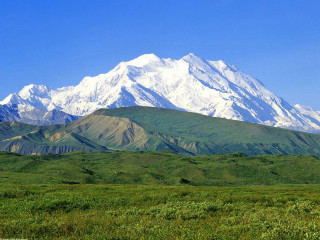 Mountain range green field blue 2 - a green field below free wallpaper