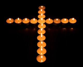 Candles cross table black background - a cross free wallpaper