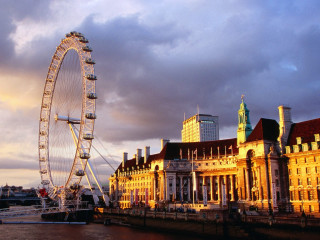 Ferris wheel building river bank - cloudy free wallpaper