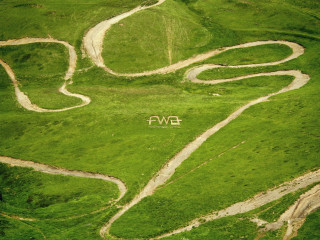 Green field white sign mountain 2 - a green field free wallpaper