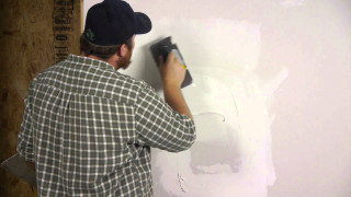 Man painting wall white paint - a wall free wallpaper