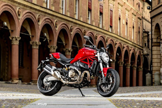 Red motorcycle parked building street - arch free wallpaper