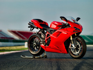 Red motorcycle parked race track - a red motorcycle free wallpaper
