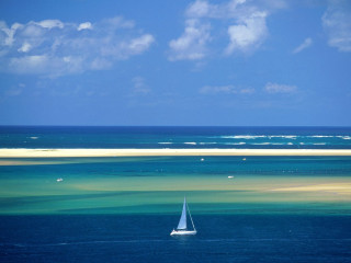 Sailboat floating ocean sky background - a sailboat free wallpaper