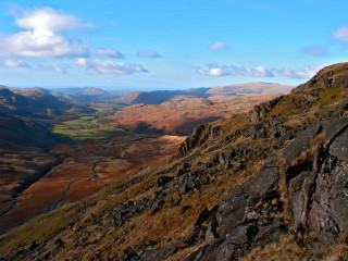 Man sitting rock mountain valley 3 - a valley below free wallpaper