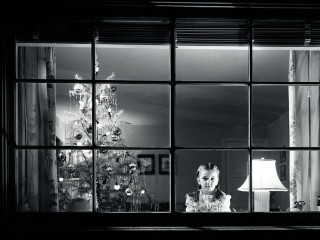 Woman looking out window christmas - american realism free wallpaper