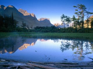 Lake mountains trees logs foreground 4 - douglas robertson bisset free wallpaper