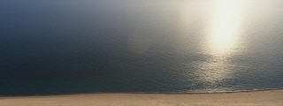 Lone boat water beach sand - zenith view free wallpaper