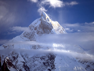 Snowy mountain cloudy sky sunbeam - a sunbeam in the distance free wallpaper