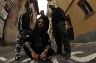 Men sitting alleyway building long - biomechanical free wallpaper