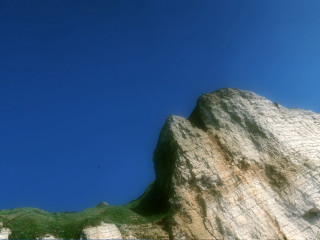 Rock formation bird blue sky - a small patch of grass free wallpaper