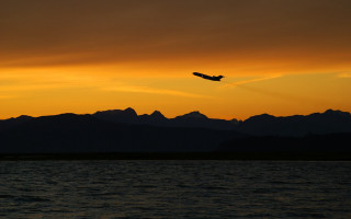 Plane flying water sunset mountains - the background and a plane free wallpaper