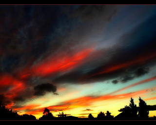 Sunset red blue sky clouds 2 - a few house free wallpaper