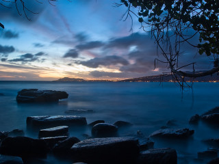 Water rocks sunset clouds view - the foreground and a sunset in the background free wallpaper