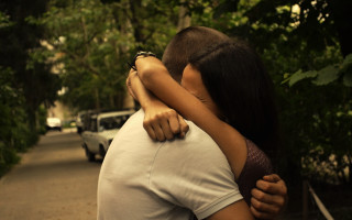 Man woman embracing street cars - daren bader free wallpaper