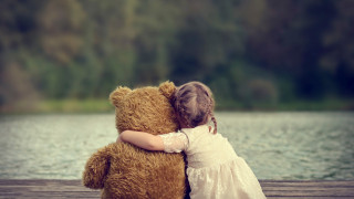 Little girl hugging teddy dock - free love wallpaper