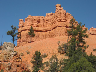 Large rock formation trees blue - a large rock formation free wallpaper