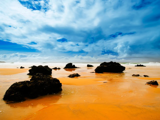 Sandy beach rocks water cloudy 5 - a sandy beach free wallpaper