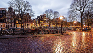 Cobblestone street buildings bicycles parked - evgeny lushpin free wallpaper