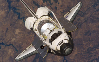 Space shuttle flying above earth 2 - free space wallpaper