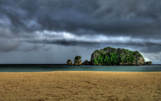 Beach rock formation cloudy sky 6 - a rock formation in the middle of it free wallpaper