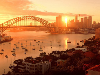 Sunset city bridge boats water 2 - the water and a bridge in the background free wallpaper