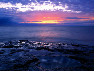 Sunset ocean rocky shore water 2 - a large body of water free wallpaper