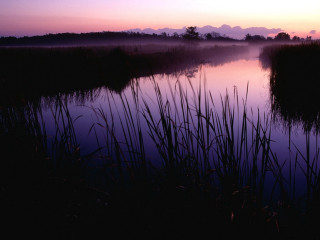 Lake reeds sunset clouds mountain - the water and a sunset in the background free wallpaper