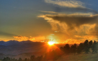 Sunset mountain clouds trees foreground - a few hill free wallpaper