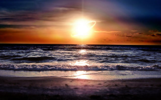 Sunset ocean wave shore sun - a sunset over the ocean free wallpaper