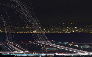 Night city lights airplanes flying - long exposure free wallpaper