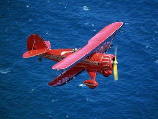 Red airplane flying ocean yellow 2 - the wing free wallpaper