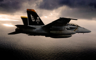 Fighter jet cloudy sky ocean - atmospheric lighting free wallpaper