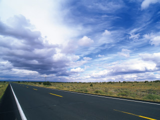 Long road cloudy sky grass 2 - a field of grass below free wallpaper