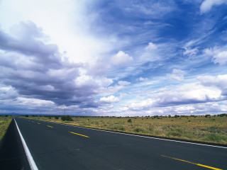 Long road cloudy sky grass 3 - a field of grass below free wallpaper