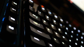Black keyboard white keys closeup - side and a blurry background free wallpaper