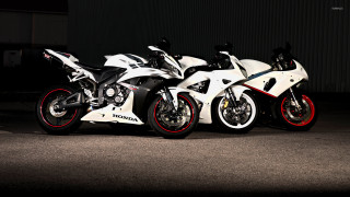 Motorcycles parked dark room wall - a wall behind them free wallpaper