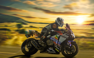 Motorcycle ride sunset field grass - the sun behind them free wallpaper