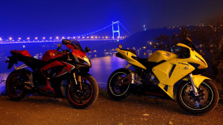 Motorcycles parked water night bridge - neon color free wallpaper