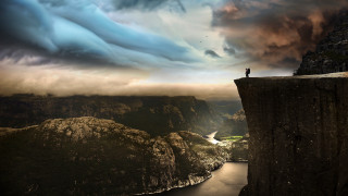 Man cliff river mountains cloudy - a rainbow in the sky free wallpaper