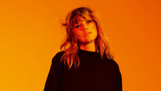 Woman longhair orangebackground blackshirt promotional - an orange background free wallpaper
