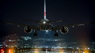 Jetliner night city lights flying - gear free wallpaper