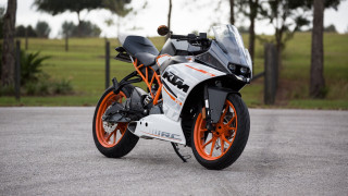 Motorcycle parked road trees grass - a park area free wallpaper