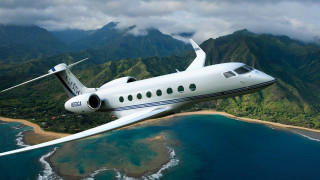 Small white plane hillside ocean - a cloudy sky free wallpaper