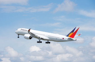 Large passenger jet flying cloudy - a cloudy blue sky free wallpaper