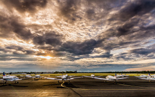 Small planes parked runway cloudy - colorful cloud free wallpaper