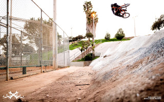 Motorcycle jump dirtroad hill fence - a fence and trees free wallpaper