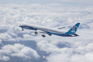 Large jetliner flying cloudy sky - international typographic style free wallpaper